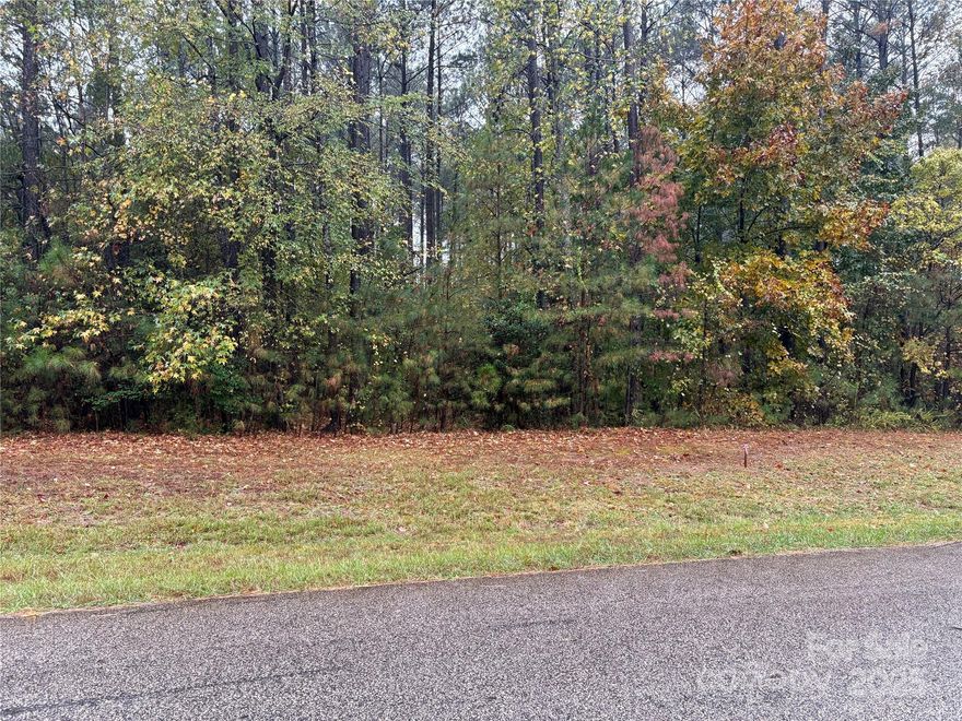 Prepare to be impressed with this .82 acre wooded homesite in desirable Riverchase Estates. Imagine living in a resort style community only 20 minutes from Indian Land, Rock Hill and Waxhaw. Surrounded by a 500 acre nature preserve, this premier gated community in Lancaster offers wooded estate sized homesites, a grand clubhouse, swimming pool, fitness center, tennis/pickleball courts and walking trails. Luxury living at its finest. A wonderful opportunity to bring your builder and build your dream home. This may be one of the nicest lots available. Schedule your appointment today!