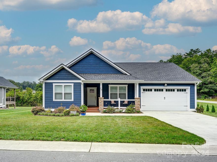 Welcome to this beautifully crafted 3-bedroom, 2-bath home in the desirable Cottages at Windy Knoll, located just 5 minutes from downtown Hendersonville, NC. Built in 2022, this 1,575 sq. ft. gem features a modern open floor plan, offering seamless flow between the living, dining, and kitchen areas. The kitchen and bathrooms boast elegant granite countertops, while the home is enhanced with stunning tile and wood floors throughout. Hunter ceiling fans add a touch of comfort to each of the bedrooms, and the custom blinds provide both privacy and style. The 2-car garage, equipped with an electric vehicle charging station, also features custom ceiling storage for added convenience. This home combines quality finishes, convenience, and style in a sought-after location!