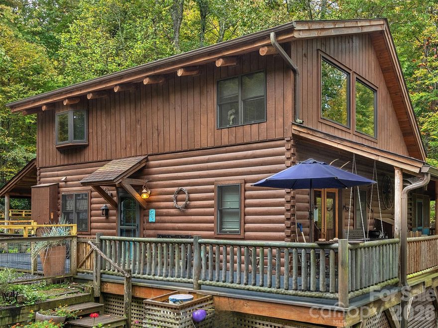 Experience refined WNC living with MOUNTAIN VIEWS in sought-after Fairview Pointe. Set on 2.72 private acres across two parcels (PINs 0605787740 & 0605785559), this beautifully crafted 2BR + loft, 2BA log-style residence offers a rare blend of rustic elegance, serenity, and investment potential. The main home, situated on 1.03 acres with tax value of $569,500 (market value minimum $575,000), showcases a desirable primary suite on the main level, soaring vaulted ceilings, and a striking stone fireplace that anchors the living space with warmth and character. The thoughtfully designed kitchen features granite countertops and stainless steel appliances, ideal for both everyday living and entertaining. Step outside to multiple covered porches overlooking your own private creek, creating a peaceful, storybook setting perfect for gathering, relaxing, and enjoying the sights and sounds of nature. The adjoining 1.69-acre buildable lot with a tax value of $63,900 (market value minimum $75,000) offers exceptional flexibility- whether for added privacy, a future guest residence, or a valuable investment opportunity. Tucked within a tranquil wooded setting just 15 minutes from Asheville, this offering captures the essence of elevated Western North Carolina living - private, picturesque, and full of possibility.