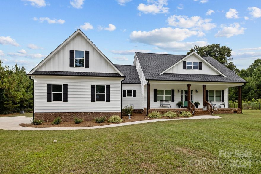 Welcome to your dream home! This stunning 4-bedroom, 3 ½-bathroom residence sits on a sprawling 6-acre lot, offering luxury and tranquility.

Inside, rich hardwood floors flow through the main living area. The kitchen is a chef's delight with granite countertops, ample cabinets, and gas hookups for your stove. Both the kitchen and bathrooms boast beautiful granite surfaces, adding elegance to your daily routine.

The spacious master suite is a true retreat with dual vanities, a separate tub and shower, and his and hers closets. Additional bedrooms are generously sized, perfect for family or guests.

This home is equipped with a powerful 460-amp service for all your electrical needs and a gas hookup for your dryer, making laundry a breeze in the dedicated laundry room.

The 2-car garage offers ample space for vehicles and storage. Outside, the expansive 6-acre property provides endless possibilities for outdoor activities, gardening, or simply enjoying the privacy.