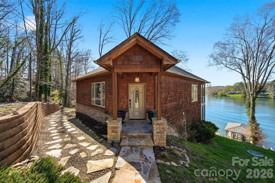 Experience lakeside living at its finest with this stunning, partially furnished home on the main channel of Lake Hickory. This gorgeous home comes complete with stylish furniture, decor, and accessories-simply open the door and start enjoying your new home. The property features enclosed decks on both the upper and lower levels, with the upper deck off the main living area and the lower deck accessible from the primary bedroom. Enjoy breathtaking sunrises and sunsets from the decks or updated dock! Nestled in a private, wooded setting surrounded by nature and wildlife, this home offers a peaceful retreat with modern updates. The beautifully landscaped grounds enhance the outdoor space, including a cozy fire pit area. With so many features and comforts, this property is truly a lakeside paradise. The septic allows for a 2BR. There is a 3rd room on the lower level that can be used as an office but has been used as a third bedroom. Jack and Jill bath shared between bedroom 2 and office. The home was previously on the market and taken off for a short term rental. Road maintenance agreement in place. Deed book 268 pg 169