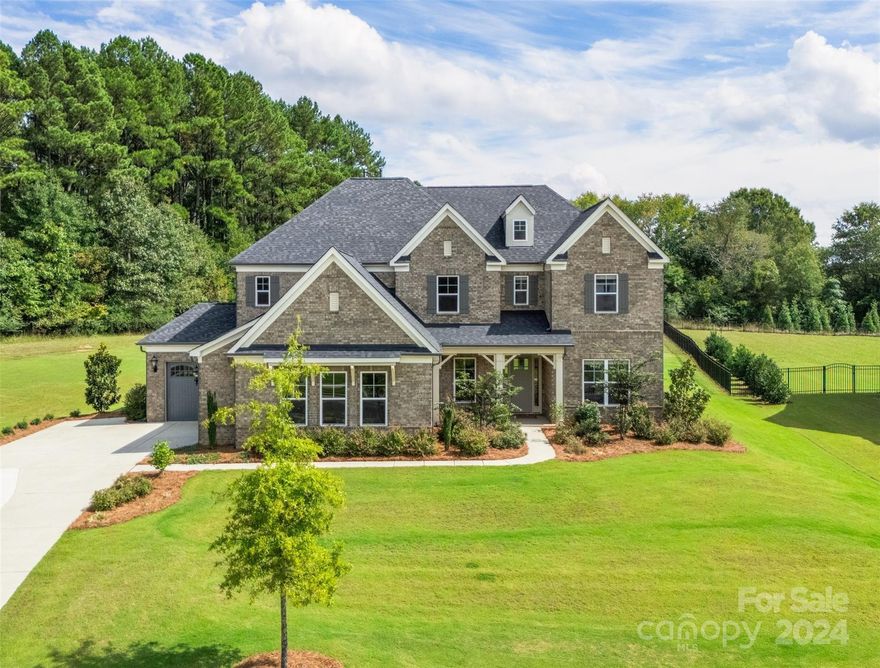 Welcome to this stunning 4-bedroom, 3.5-bath modern home, perfectly set on one serene acre surrounded by woods. The enormous kitchen features high-end KitchenAid appliances and a gas range. The expansive kitchen island flows seamlessly into an open floor plan that's ideal for entertaining. The main-level primary bedroom offers a luxurious bath with a rainfall shower and exquisite finishes throughout.
Relax on the peaceful screened porch or in the professionally landscaped yard, perfect for outdoor entertaining. This Smart Home has the latest technology including keyless entry, Nest thermostats, and wireless access points on both floors. In home audio and Sonos-adaptable speakers add to the amazing features of this home.  Movie night just got better in the surround-sound ready bonus/media room.  
Located in the sought-after Weddington High School district of Union County you'll be close to shopping and have easy access to Providence Rd., I-485, and Hwy 74.