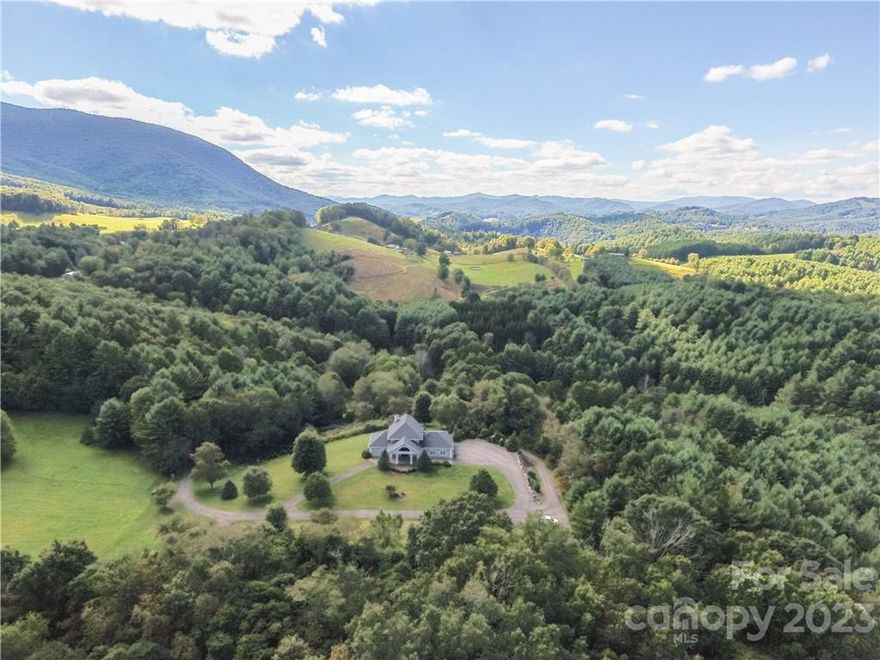 Rocky Ridge Farms: 72+ acres of wooded privacy w/ layered mountain views, open meadows, pastures, large boulders & rock outcroppings, streams/creeks, hiking & ATV trails, a pond, barn, shops/garages, spacious main home, & guest cabin! Drive by a cascading waterfall, through gated entry, & down a park-like entrance to the main house, resting in a picturesque setting atop a grassy knoll with paved circle drive, covered entry, 3 car garage, & lower utility garage/workshop! The main home offers 3BR, 3BA, & 2 half baths with living areas on each of 3 floors, as well as open & screened decks, 2 stone fireplaces, open kitchen, wood/travertine/marble floors, elevator, wheel chair accessibility, wine nook, bonus room/office, & wall of windows framing in the view. Nearby, yet in a separate & private setting, is a 2BR 1BA Guest Cottage with open floor plan, covered wrap-around porch, & 'babbling brook'! Property Features: bridge @ gated entry, equipment garage/shop w/ power/bathroom, waterfalls.