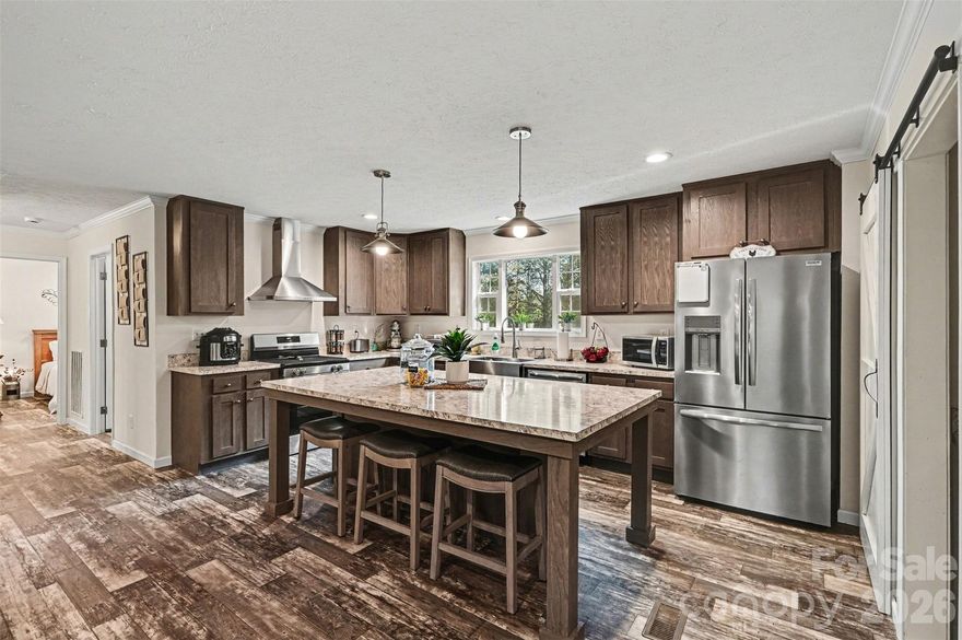 Like new! 2024-built home featuring a desirable open floor plan with granite countertops, pantry with stylish barn door, and neutral colors throughout. This home offers 3 bedrooms and 2 bathrooms with a split bedroom plan for added privacy. Enjoy outdoor living with a covered front porch and a back deck overlooking the expansive 1.46-acre lot—perfect for relaxing or entertaining.