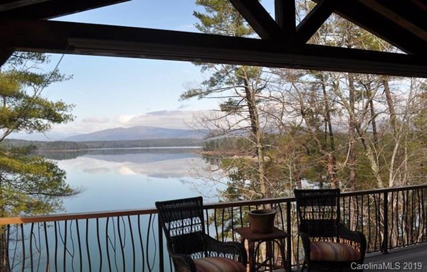 Amazing stone & timber cottage in private community on, pristine lake surrounded by protected forests. Clear views across one mile of open water to Lake James State Park on the opposite shore. French Gothic timber frame w/ custom lodge details, stone walls, faux slate roof, copper roof metal & one-of-a-kind architectural sculptures & maple flooring throughout; all in the Adirondack tradition. Large lakeside deck on ground & main floor, floating dock, gazebo on the water, cedar sauna for 6, porte-cochere, roof top balcony, large lighted cupola, 2 story fireplace, kitchen garden, mature landscaping & plenty of parking. Spacious yet cozy with 7 BR, 71/2 BA plus office, family room, full basement & 2 car garage. The perfect home for watersports & entertaining w/ a big WOW factor.  www.mountainlakehouse.us for info & pics!