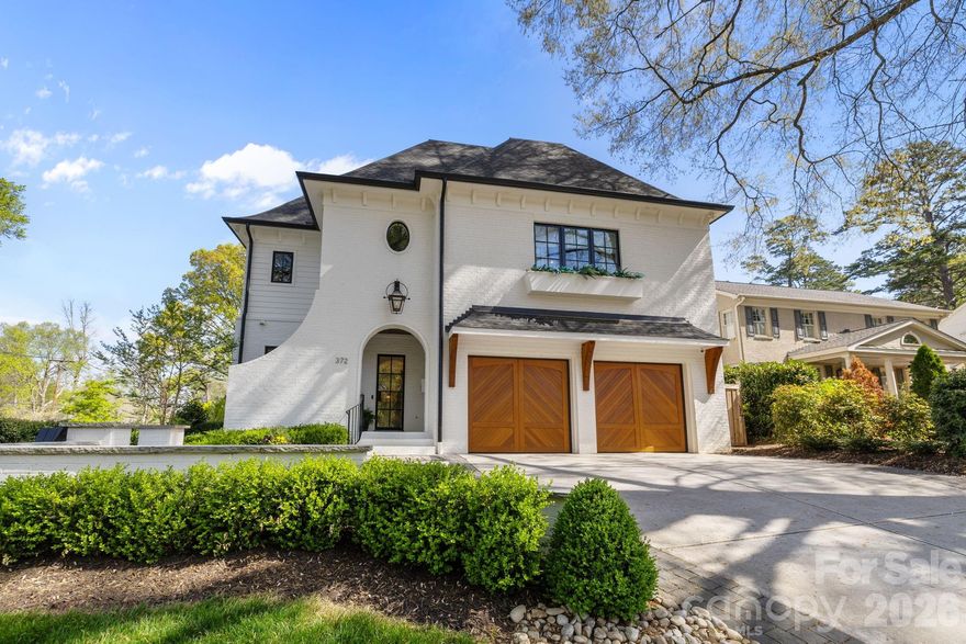 Welcome to 372 Hillside Avenue!  This stunning townhouse built in 2021 is your answer to turn key living in the heart of Myers Park. The sophisticated design includes an open floorplan and elevated finishes throughout.  The covered front porch, steel front door and curved architectural features exude charm as you enter the property.  High ceilings, site finished oak hardwood floors and archways welcome you into the entrance foyer.  The Chef's kitchen includes Wolf, Sub Zero and Bosch appliances  (48" dual fuel range, custom hood, 42" built-in-fridge, dishwasher, wine fridge) and a center island with bar seating. Walk in pantry with a built in desk / house management area.  The great room and dining room share an open generous space plus a custom designed bar with a wine fridge. The living areas blend comfort and style with built-in shelving on either side of the fireplace, scone lighting and double doors to the side screened in porch. The porch has stone flooring, tongue & groove ceilings and a ventless gas fireplace insert. Great drop zone / mud room at the interior entrance from the attached 2 car garage. The upper level includes an incredible primary bedroom suite and three other secondary bedrooms and a laundry room. The primary bedroom has a huge walk-in closet with custom built-in drawers, shelves and expansive hanging options - truly a dream. The spa bathroom has a soaking tub, spacious shower, a water closet and custom built-in linen storage. The secondary bedrooms are all generously sized with well organized closets. The third floor is flex space that be tailored to your personal needs and includes 2 walk-in storage areas.  Attached 2 car garage with great storage systems in place. In addition to the private screened porch, the property has a blue stone patio and side yard with professionally designed, mature landscaping. Unmatched location with direct access to the Sugar Creek Greenway and walking distance to retail and restaurants on Selwyn and Park Road Shopping Center.