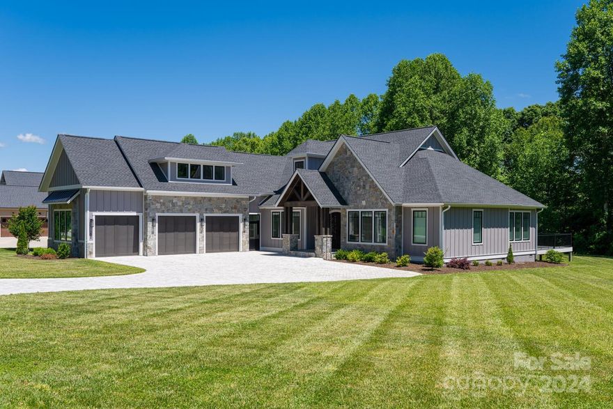 This home has it all! Gorgeous custom 2yr old open floor plan home is like new construction without the wait! Perfect home for entertaining. Incredible attention to every detail! Impressive almost 12' ceilings in main area. Gas fireplace. Large windows make the home sunny & bright. Impressive 8' tall doorways throughout. Kitchen is a chef's dream with 12' marble bar, seating for 6, high-end appliances, undercounter lighting, lots of custom cabinet storage. Enjoy relaxing on the covered deck with built in grill. Upstairs has endless opportunities from an ensuite bedroom, movie room or workout room. Large sized custom closets throughout. Beautiful bathrooms with marble and porcelain counter tops. Spacious mud room with laundry right off kitchen area. Central vacuum system. 3-car garage complete with electric car hookup. Paver driveway. Have we mentioned - so many upscale features! Located in gated Skytop Farms with pool, walking trails and green space along the French Broad River.