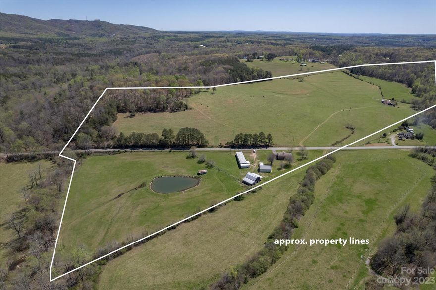 Stunning mountain views, rolling green pastures, barns & buildings galore plus a creek & pond - everything one might want for the modern homestead!  This endearing rural property has been lovingly lived in & farmed for generations.  Solid 3 bed/1 bath brick ranch w/full unfinished basement.  Large metal outbuilding/shop with separate electric panel, concrete floor & sliding barn door.  Huge tin-roofed barn w/hay loft, shed outbuilding, plus a standing roof building to protect those invaluable tractor implements.  Area around pond is fenced w/gate & offers a stalled structure.  Across the road, you'll find a gorgeous wooded hilltop overlooking the pasture below that would make an amazing second homesite.  More stalls and fenced pasture currently being used for cows.  If you've been dreaming of wide open spaces, don't miss this 89 acre gem!