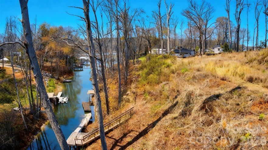 Canal-front homesite on Lake Norman located in Sherrills Ford. This property offers calm water ideal for kayaking, paddleboarding, canoeing, and other low-wake recreational activities.

The lot provides a gently sloping setting suitable for a future custom build with wooded surroundings that offer privacy and natural scenery. Select clearing could open additional views of the canal and enhance the homesite.

Conveniently located near Highway 150 with easy access to Mooresville, Denver, Lake Norman marinas, dining, and shopping.

Opportunity to build near Lake Norman in a growing area. Bring your builder and design your vision.