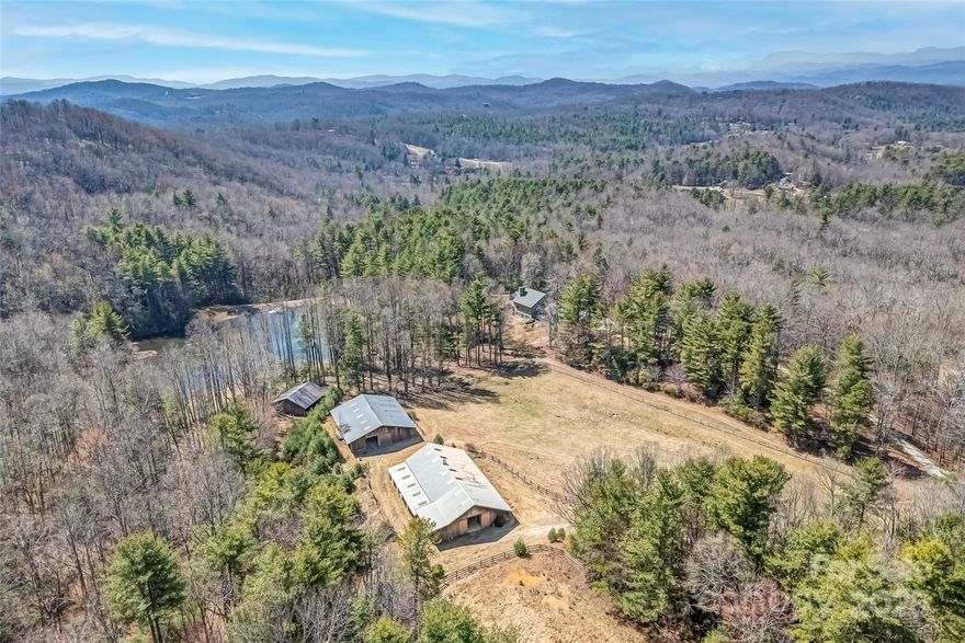 A high-elevation legacy ranch between Brevard and Dupont State Forest that's close to everything but incredibly private. It is the kind of property rarely available and provides the ultimate retreat you've been dreaming about. The adjoining neighbors at Eagle Lake provide a clean approach to your large estate land. Previously utilized as a year-round residence and Arabian horse farm, this property has many versatile improvements and permitted uses. An architecturally designed home sits in the heart of the land, overlooking views of the lake, pastures, and wildlife. Additionally, there is a 6000 sqft barn with w/an apartment and more. The high-elevation property is exceptional, with pristine natural springs originating on the property and flowing down into your private lake to beautiful pasture land with year-round long-range blue ridge mountain view potential. There is too much to mention. This property must be experienced in person to understand fully. See the virtual tour video!