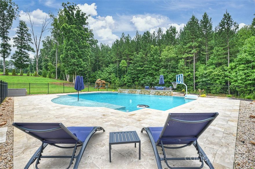 WELCOME TO YOUR OWN PRIVATE, BACK YARD OASIS! This home is situated on a tree lined double lot, with one of the largest pools around! Enjoy quiet evenings on your two-tier screened deck, offering uninterupted views of nature! The house is situated on a peaceful cul-de-sac, with a spacious 1.6ac double lot. The house has open layouts, 5bdrms, 4.5 baths, a 2 story great room, a gourmet kitchen and a huge finished basement, that could easily become an in-law suite. The basment also offers a walk in, shelved storage room and a vaulted safe room....perfect for a wine cellar or a cigar lounge!  Enjoy exclusive access to community amenities like the pool, tennis courts & playground, all while benefiting from low Iredell Co taxes! 
This house has it all & is a MUST SEE!!
MOTIVATED SELLER!