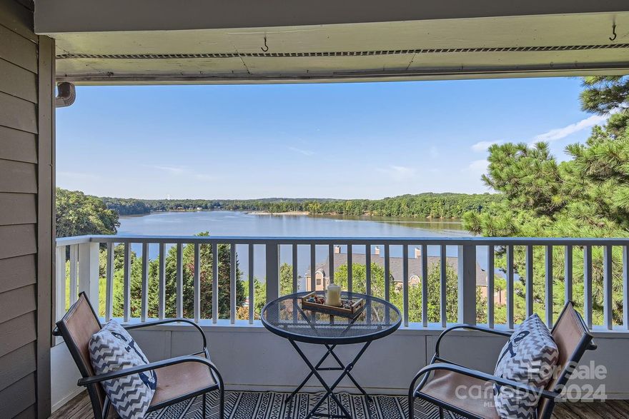 Welcome to Emerald Point, where stunning Lake Wylie views greet you the moment you walk through the front door! This upgraded 2-bedroom, 2-bath condo offers a modern kitchen with quartz countertops, a stylish island, and a beautiful wet bar. The inviting living room showcases a wood-burning fireplace, tray ceiling, and a convenient office nook. The primary bedroom is a retreat featuring a spacious bath, garden tub, double sinks, and a walk-in closet. Step outside to your private deck with breathtaking lake views, and enjoy exclusive access to your own boat slip complete with a boat lift and a community pool!  Ideally located near Berewick shopping, the airport, and major highways, this is lakeside living made easy. Welcome to your perfect resort style home!