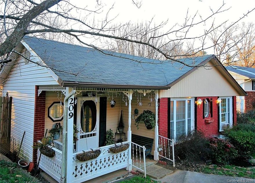 Live on main level and rent income producing lower level apartment w/strong rental history. OR, use basement for additional living space, studio, home office, in-law suite. Easy access to hwy 70 and I 40 about 12 minutes from DT Asheville.  Two gas fireplaces, two decks, hot tub, fenced yard and plenty of parking off street in carport and driveway. Lower level apartment is spacious. Street to be repaved as sewer lines were just replaced. Seller motivated & will consider all reasonable offers