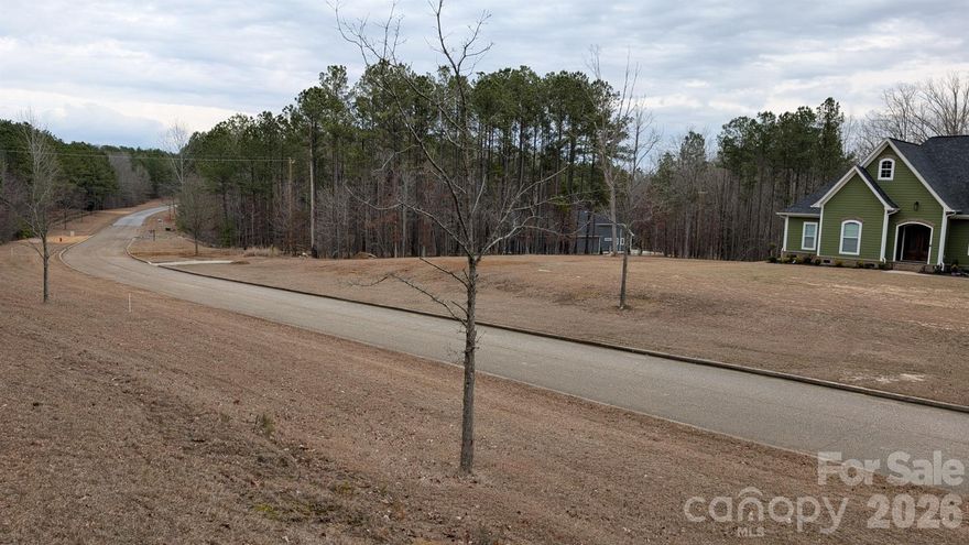 A two acre building lot located inside of Lake Wateree's premier gated community, The Woods of Molly Creek. Property is out of flood zone, level, ready to build on. A preliminary septic system testing report available indicating a conventional septic system will be approved. HOA fee is $1,000 per year. Public water available. Architectural plan review required. A very nice area with nice homes, streets and security of a gated neighborhood. LOT 3 , additional lots available to choose from.
