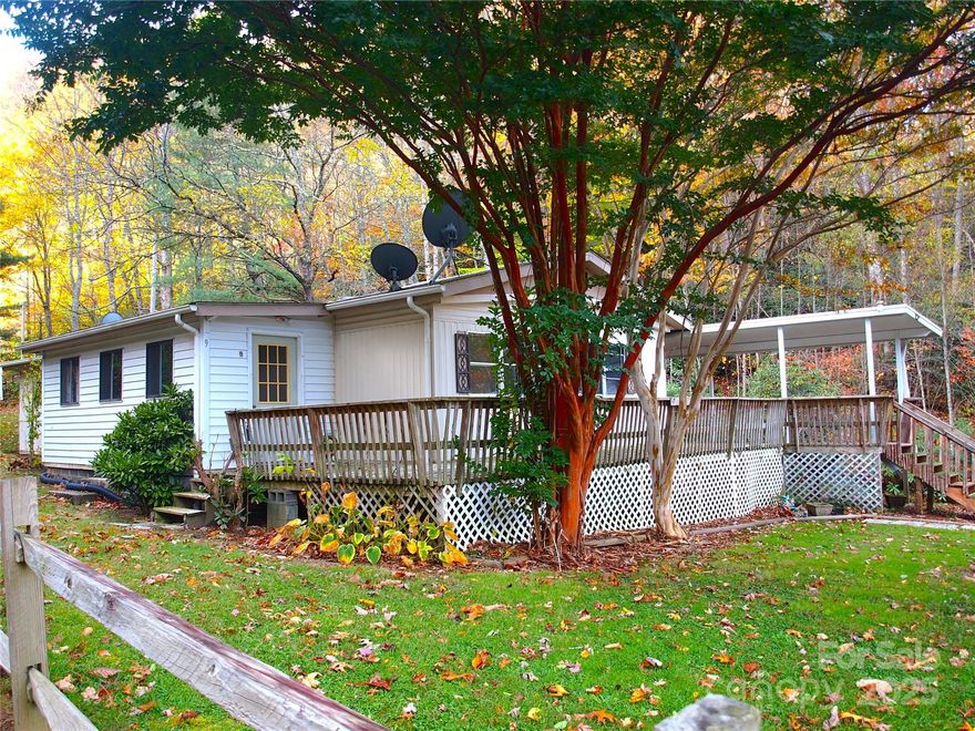 HUGE PRICE REDUCTION!! Located at the base of majestic Cold Mountain, this spacious home is perfectly situated for mountain living. Its defining feature is the view of bold flowing Dix Creek, making it an ideal spot for morning coffee or evening gatherings. The partially covered deck section provides welcome shade during the summer while allowing the rest of the deck to soak up the sun, all with the serene sounds of the water providing a constant, soothing soundtrack.  
Also included are two camper sites, with separate septic system,  offering a perfect, ready-to-use escape for RV enthusiasts. The camper spaces are positioned for privacy, each equipped with full hookups for water, sewer, and electricity, ensuring a comfortable, hassle-free stay. Mature trees provide ample shade throughout the property, keeping the spaces cool and private, while the peaceful sound of the babbling creek creates a tranquil backdrop for unwinding and enjoying nature. With the convenience of modern amenities and the rustic charm of a creekside setting, this lot is ideal for a seasonal retreat or a permanent home base for those seeking a quiet, natural environment with easy access to recreational activities.