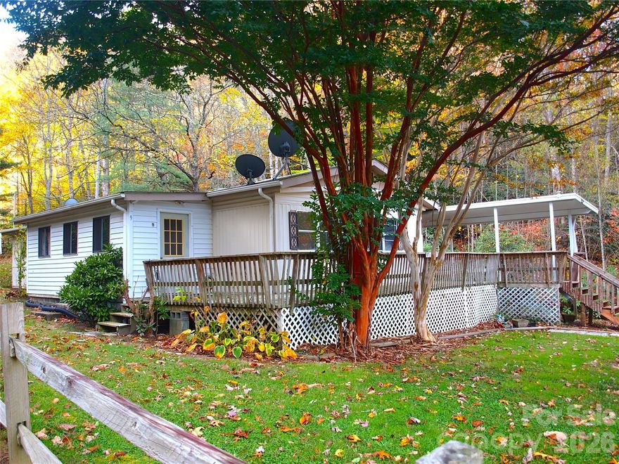 HUGE PRICE REDUCTION!! MOTIVATED SELLERS!! BRING AN OFFER!! Located at the base of majestic Cold Mountain, this spacious home is perfectly situated for mountain living. Its defining feature is the view of bold flowing Dix Creek, making it an ideal spot for morning coffee or evening gatherings. The partially covered deck section provides welcome shade during the summer while allowing the rest of the deck to soak up the sun, all with the serene sounds of the water providing a constant, soothing soundtrack.  
Also included are two camper sites, with separate septic system,  offering a perfect, ready-to-use escape for RV enthusiasts. The camper spaces are positioned for privacy, each equipped with full hookups for water, sewer, and electricity, ensuring a comfortable, hassle-free stay. Mature trees provide ample shade throughout the property, keeping the spaces cool and private, while the peaceful sound of the babbling creek creates a tranquil backdrop for unwinding and enjoying nature. With the convenience of modern amenities and the rustic charm of a creekside setting, this lot is ideal for a seasonal retreat or a permanent home base for those seeking a quiet, natural environment with easy access to recreational activities.