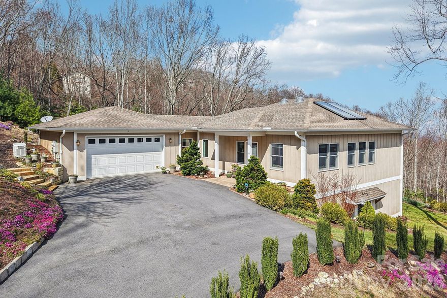 A study in serenity and mountain elegance, this Silver green-rated home is perfectly sited on 1.72 acres to take full advantage of its extraordinary long-range views and breathtaking eastern sunrises. From the first light of day, the horizon is washed in brilliant hues of rose, coral, and gold, creating a daily experience as beautiful as it is peaceful. Designed with both sophistication and livability in mind, the residence offers the ease of main-level living with the kitchen, primary suite, primary bath, laundry, and garage all thoughtfully positioned on the main floor. Rich finishes elevate the interiors, including granite countertops in the kitchen, quartz countertops in every bath, generous storage throughout, and a level of care and maintenance that is immediately apparent. The lower level offers substantial flex space and lives with the comfort and privacy of a nearly independent guest retreat, ideal for extended stays, entertaining, office space, or recreation. Distinctive, beautifully finished, and surrounded by the quiet beauty of the mountains, this is a home that invites you to slow down, take in the view, and live exceptionally well.