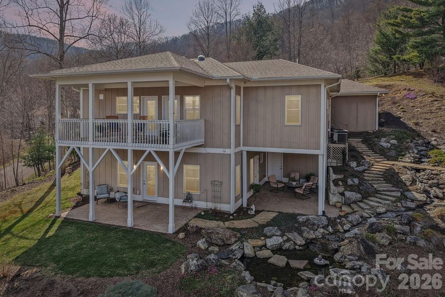 A study in serenity and mountain elegance, this Silver green-rated home is perfectly sited on 1.72 acres to take full advantage of its extraordinary long-range views and breathtaking eastern sunrises. From the first light of day, the horizon is washed in brilliant hues of rose, coral, and gold, creating a daily experience as beautiful as it is peaceful. Designed with both sophistication and livability in mind, the residence offers the ease of main-level living with the kitchen, primary suite, primary bath, laundry, and garage all thoughtfully positioned on the main floor. Rich finishes elevate the interiors, including granite countertops in the kitchen, quartz countertops in every bath, generous storage throughout, and a level of care and maintenance that is immediately apparent. The lower level offers substantial flex space and lives with the comfort and privacy of a nearly independent guest retreat, ideal for extended stays, entertaining, office space, or recreation. Distinctive, beautifully finished, and surrounded by the quiet beauty of the mountains, this is a home that invites you to slow down, take in the view, and live exceptionally well.