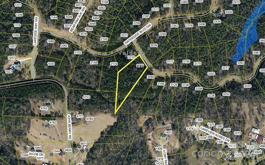 Enjoy a 2.74 acre lot in the beautiful Waterside Subdivision... a gated lakefront community on Lake Rhodhiss in Valdese! Per the seller, there is a mostly level spot for a home at the top of the property or build where buyer prefers on the lot. Wooded and private! The Waterside Subdivision offers community boat slips, a community lakeside park, and winding roads offering privacy. This development has underground utilities, access to city water (tap fee required) and city sewer (tap fee required) at the street, & has city trash and recycling pickup too. HOA dues are: $300 per year. William Douglas Property Management manages the HOA...(704) 347-8900. Bald Eagle Nests nearby which are protected. Town of Valdese taxes and Burke County taxes are together on one tax bill thru Burke County. This lakefront community is minutes to downtown Valdese and conveniently located between Hickory and Morganton! Large lots, being newly developed, and private! You will like what you see! CALL TODAY!