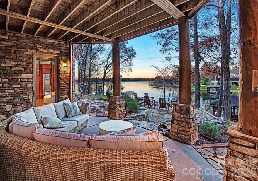 RARE OPPORTUNITY to own the "Timberlake" - a one-of-a-kind luxury Lake Norman retreat.  Truly unique in appearance and build, this gorgeous custom log cabin was built with hand hewn eastern white pine and cedar from an old stand of timber in the mountains of Virginia and Tennessee.  Previously part of the Inspirato private collection, this handcrafted estate offers both the opportunity of primary living or investment. With curated finishes and outstanding architecture, this home has been meticulously appointed to the most delicate of details and offers stunning waterfront views perched from the expansive decking, living/bedroom spaces and the 3 story window walls in the great room. This show stopping compound provides a 5 star lake experience, 175 feet of shoreline, stone/fire patio area, dock and covered boat slip. Nature abounds this picturesque property where you'll immediately find serenity and relaxation. Close to Trump National Golf Course, restaurants, shopping and more. Furniture, boat and jet ski available upon accepted offer.