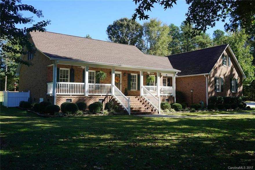 Beautiful all brick home. Large country front porch. Light, updated interior that is ready to move into! Enter living room w/ gas logs fireplace that leads into bright open kitchen with all appliances & island. Large covered porch and patio for relaxing and entertaining. Formal dining room with exit to patio; large laundry with sink & storage; master bedroom with sitting area & his & her closets in bath. Unfinished attic has great possibilities. 2 wired buildings for storage and workshop.