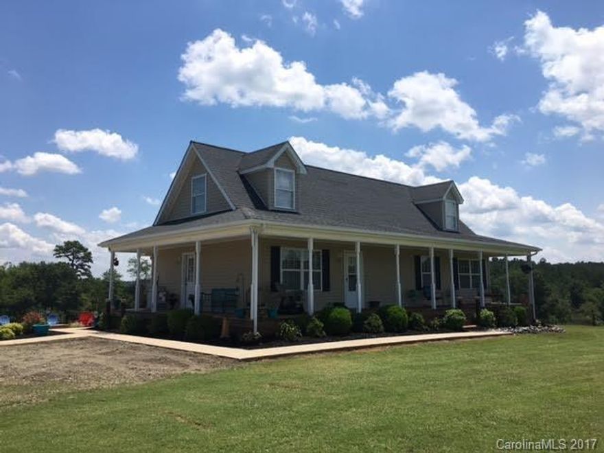 Perfectly situated on a knoll overlooking pastures. Beautifully designed 4 bedrm 3 bth All American Home w/ plenty of room to grow. Plumbing in unfinished basement. Covered porch awaits you on the front & patio & fire pit invites you to sit a spell out back. Master bdrm on main floor w/ a master bath & walk in closet. Commercial water system & 2 heat pumps. 3 car carport w/ RV parking area. To be surveyed prior to closing & approx. 3.5 to 4 acres with the driveway included.  Minutes from TIEC.