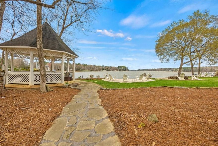 This gorgeous completely updated 4 bedroom 3 bath home located on Lake Wylie is the perfect blend of luxury and comfort. The open concept living area features a huge kitchen island that is perfect for entertaining guests or preparing family meals. The kitchen is equipped with top-of-the-line appliances, granite and marble countertops, and custom cabinets. The family room offers breathtaking views of the lake and is the perfect place to unwind after a long day. The screened-in porch is ideal for enjoying a morning cup of coffee or an evening cocktail while taking in the scenic views. The property also includes a beach area, a boat lift and gazebo for outdoor gatherings. Whether you enjoy fishing, boating, or swimming, this home offers the perfect location to indulge in all of your favorite water activities. With its spacious and open layout, gorgeous lake views, and incredible outdoor amenities, this home is sure to impress. Don't miss your chance to make it your own!