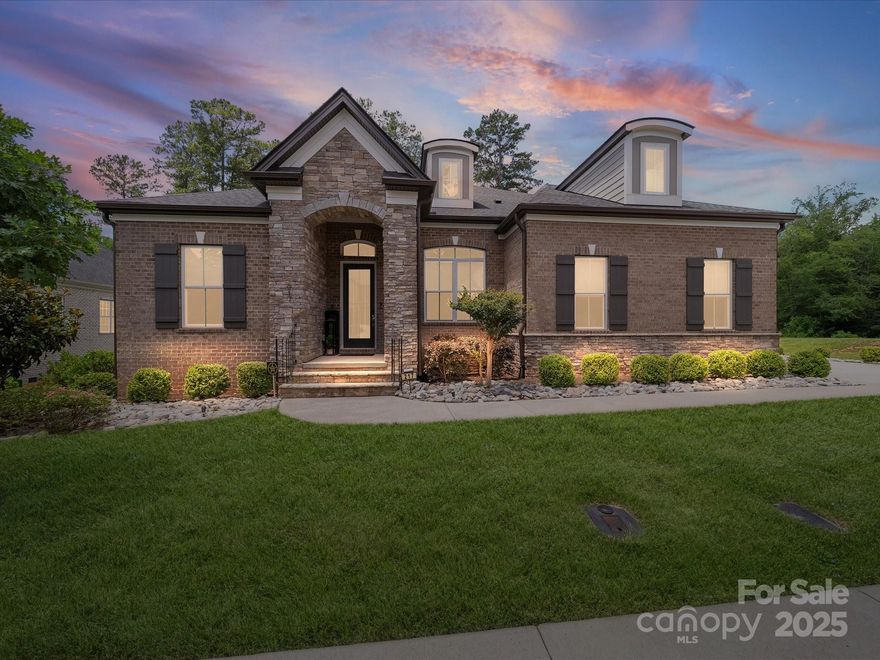 Meticulously maintained 5BR/5.5BA custom home in sought-after Falls at Weddington, offering 4,000+ sq ft of refined living. This timeless, neutral palette home invites you to envision your own color scheme throughout its curated spaces. Main level features a luxe primary suite w/soaring ceilings, oversized walk-in shower, dual vanities & custom closet w/private laundry access. Three add’l main-level BRs ideal for multi-gen living or guest space. New hall half bath adds convenience. Chef’s kitchen boasts quartz counters, SS appliances, oversized island & scullery for prep. Coffered ceilings & wide-plank laminate wood flooring throughout main. Upstairs includes private guest suite & spacious media/entertaining room. Newly finished full bath on lower level supports exceptional outdoor living. Enjoy year-round relaxation in the 4-season enclosed porch overlooking PebbleTec in-ground pool & beautifully landscaped yard. Smart home features and 3-car garage complete this move-in ready gem.