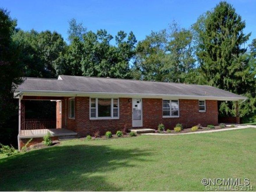 Bent Creek Area. 1.5 mile to Arboretum, Trailheads, Parkway, & French Broad. Mid-Century updated Brick Rancher.  1.57 very usable acres, large garden space, fruit trees, grapes. Huge Living Room & Kitchen space. Wonderful covered porch for evening relaxation.  Main level carport, Daylight basement w/2 garages, pottery shop.  Clean, Bright and Move-in Ready!!  Newer HVAC, 200 Amp service. HARDWOODS under carpet. Listing agent related to the Seller