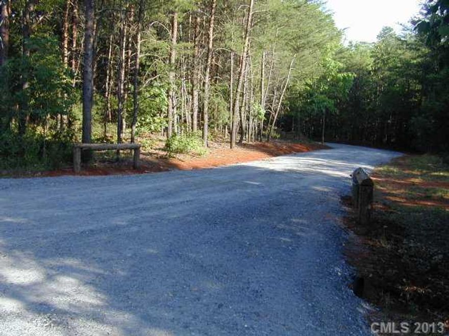 This beautiful lot is ready to build your dream home with all the privacy one could want. 800 ft scenic driveway through the woods. Lot faces a 2 acre stocked pond located on HOA property. The HOA also has a 7acre lake. Only 10 homes in neighborhood and all have acreage lots. HOA ownes 17 acres total.Lot has been perked. Agent is owner