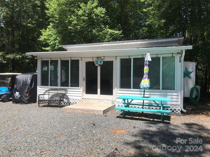 PRICED REDUCED! Come & see if this adorable unit is your "Happy Place". The 28' Aerolite 2006 has been freshly updated, it is bright & fun w a full addition!! The addition has so much glass that you feel like you are outside but you have the comfort of heat & A/C. This large lot that has plenty of room for all your cars & toys. There is a quiet area out back that looks at the woods. Step into the addition that has an updated kitchen w/ full size applianecs, New flooring,paint,windows& doors. There is pull out sofa in the living area, nice table in the dining area. The camper has 1 bedroom queen bed. There is a twin bed & a camper couch that makes a bed for lots of sleeping. Good storage. The outbuilding is 10 x 8 w power, washer hook up w a washer to remain. There is a new propane H2O on demand. Plenty of storage throughout. Mobile a/c in addition, camper a/c works for camper. Elec Fireplace blows heat in camper, no flames. 2 other portable heaters. 2011 gas golf cart included.
