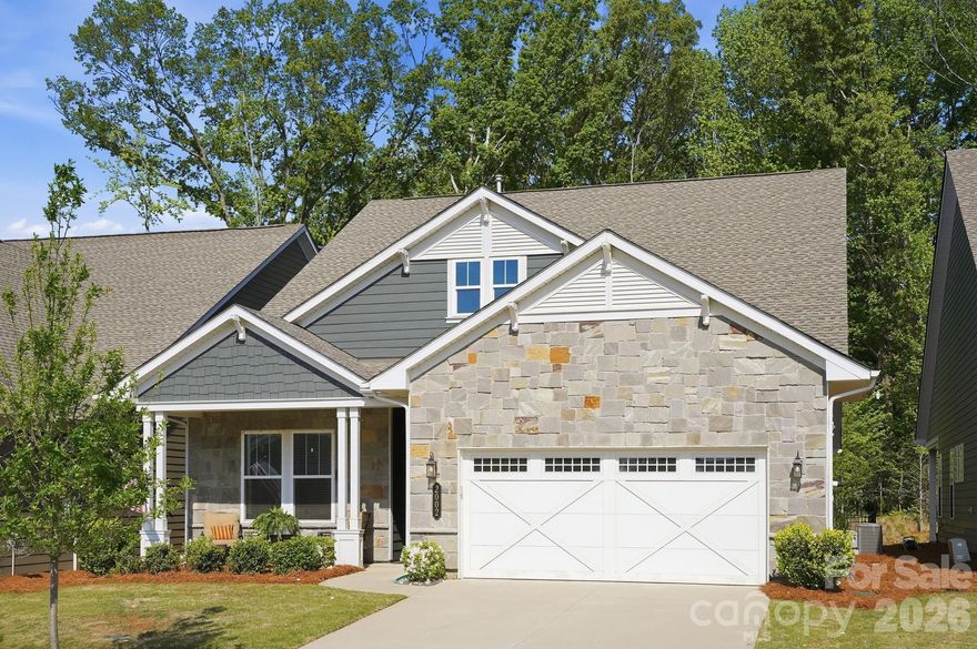Enjoy this move-in ready home with no rear neighbors!  This stunning Charlotte area home offers privacy, style and comfort in the highly desirable 55+ Cresswind Wesley Chapel community. Step inside to discover a thoughtfully designed layout adorned with high ceilings and premium upgrades including new hardwood floors downstairs and custom designed paver patio. Professionally landscaped and fenced backyard. The kitchen is a true standout featuring quartz counters, gas cook top, premium backsplash, walk-in pantry, custom pull out cabinet drawers and stainless steel appliances. The large island with bar seating makes it perfect for entertaining, while the open-concept design flows seamlessly into the living and dining areas. Enjoy the tranquility that the gas fireplace in the great room has to offer. The upper level bonus room complete with full bath and multiple closets creates that additional perfect storage space every homeowner longs for! Enjoy quiet mornings or evening gatherings on the peaceful lanai patio overlooking your very own tree lined view. With resort-style amenities including clubhouse, pool, pickleball, tennis, social clubs, scenic walking trails, high speed internet and lawn care this gem provides a true blend of balanced luxury, exceptional lifestyle and carefree resort-style living. Welcome home to 2002 Belle Mont Farm!