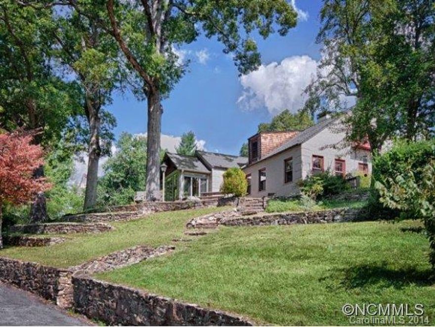 Incredible privacy on 2.3 acres right in North Asheville on a hilltop knoll with huge towering oaks, stone walls, large lawn, incredible gardens, mountain views. Hardwoods in all living and bedrooms, 48" Dacor gas range and beautiful maple cabinetry in recently updated kitchen, freshly painted interiors, new HVAC upper level. Precious two-story log cabin with new HVAC, paint and built-ins. Minutes to Beaver Lake, Fresh Market and restaurants.