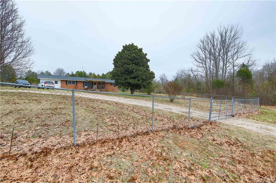 Looking for privacy and country living at its best?  Look no further!  Freshly painted in warm neutrals, this great brick ranch home on almost 5 acres features updated flooring, hardwoods, tiles, and carpet, with over 1,300 sq ft of living space.  Part of the property around the home is completely fenced and has a utility building for plenty of storage.
