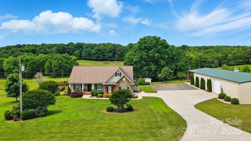 Stunning luxury estate for sale in Mount Pleasant, NC on 18 acres with two ponds, fenced pastures, & horse stable; perfect for equestrian living. This custom home offers nearly 3,600 sq ft with a walkout, finished basement, hardwood floors, & a main level primary suite featuring two walk-in closets & a spa like en suite bath. The gourmet kitchen includes granite countertops, stainless steel appliances, and an island with seating. Enjoy the spacious living room with vaulted ceilings and a stone fireplace. Outdoor living shines with a covered porch, patio, & serene views. A detached 5,000+ sq ft workshop includes a private office & oversized doors; ideal for RVs, business use, or storage. Located minutes from Concord & an easy commute to Charlotte, this Mount Pleasant property blends luxury, privacy, and functionality. Ideal for homebuyers seeking acreage, space for animals, & a high end home in a peaceful, rural setting. A rare opportunity so please schedule your showing today! NO HOA!