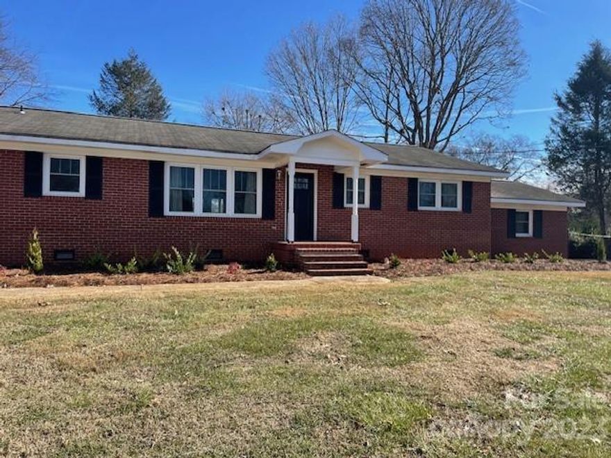 Location Location Location. This brick ranch is in the heart of Spindale in walking distance to the library, restaurants and the  rails to trails. Situated on .94 of an acre this property has so many possibilities. The back yard is fenced in for pets and there is also a rear drive accesable from Tanner Street. Step into an open floor plan with an oversized living and dining area great for entertaining. Improvements in 2019 are all new cabinets, countertops, flooring, windows, HVAC, lighting fixtures and paint. New landscaping in 2023. Sit on the back porch and enjoy your coffee in this peaceful neighborhood. There is an exterior she shed/man cave that has built in storage and room for all your Christmas decor and lawn care tools. Agent related to owner.