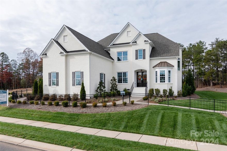 Popular Belaire - decorated model home. Lot backing to mature trees for terrific privacy. 4 sides painted brick exterior. 5 Bedrooms -Premier Suite on upper floor w/ a well-appointed premier bath. Plus a private guest suite on the main level. Open kitchen/family room great for entertaining. Formal living and dining rooms off the two story entry foyer. Mud room off garage with drop zone. Spacious bedrooms up - one with its own bath and a Jack-n-Jill bath for the other two bedrooms. All with great closet space. Convenient laundry room just off the mud room w/ cabinet and quartz counter top and a sink. Creamy white painted kitchen cabinets stacked to the ceiling w/ large center island and gourmet appliances. Terrific bonus room up perfect for media. 3 car side entry garage plus 1 car carriage garage. Covered Rear Deck w/ outdoor gas fireplace. Luxury finishes throughout. Terrific neighborhood