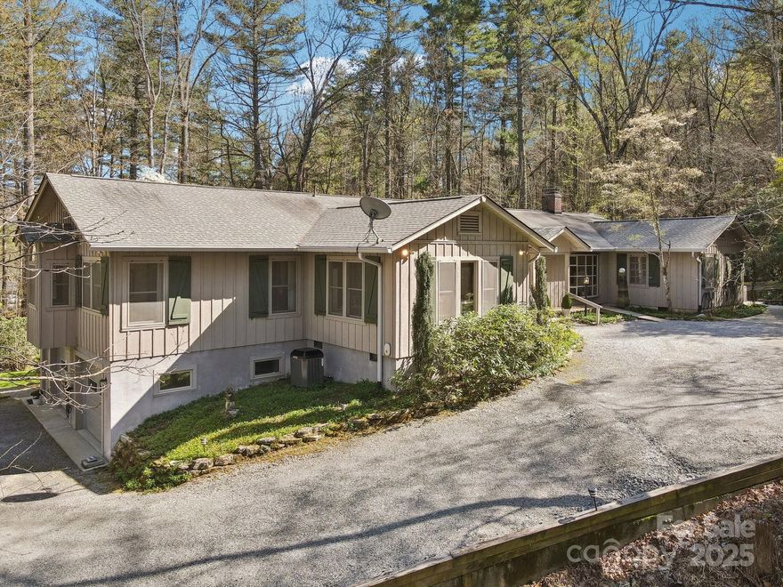 Spacious home on 5 acres with many custom features, character and charm throughout.  Douglas fir wood flooring in living room, kitchen, dining room & front entry hall.  Living room w/wood burning stove, bay window & built-in's.  Kitchen w/custom cherry cabinets, hand-made tile backsplash, walk-in pantry, breakfast bar.  Three bedroom, three bath plan.  Study w/hand-crafted bookshelves.  Hobby/craft room w/sink, cabinets, closet and outside entrance. 30' x 12' screened porch, large flagstone terrace with water feature, claw foot tub w/hot/cold shower, two decks.  Many custom doors, ironwork hinges and handles, electric car charger, new generator, encapsulated crawlspace, two car garage in basement.  Wooded privacy w/winter view of Pinnacle Mountain, neighboring Kanuga Conference.