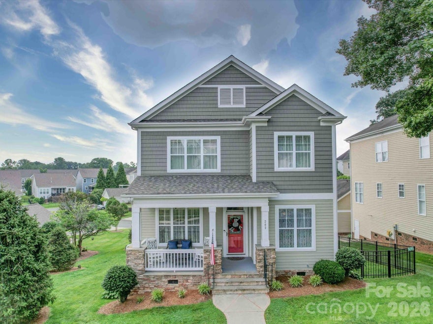Welcome home to "Christmas Town USA!" Experience the height of craftsmanship in this stunning home located in the heart of picturesque McAdenville. From the lovely front porch to the detailed wood trim, high ceilings, and flooring throughout, every inch of this home exudes quality and charm. The light filled living room, anchored by a cozy gas fireplace, flows seamlessly into the dining room. The gourmet kitchen features elegant cream cabinetry, granite countertops, and premium stainless steel appliances. With the primary suite conveniently located on the main level and featuring a large ensuite bathroom and walk-in closet, you have a true peaceful retreat to call your own. Three spacious upstairs bedrooms offer flexibility for a home office or playroom, while ample storage in the basement ensures a place for everything.  The newly added fence provides privacy and a place for your kids or furry friends to play freely.  It's more than a house, it's a home built for those who appreciate style and community spirit, a place to create lifelong memories with fmaily and friends.