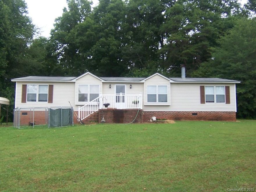 Spacious double wide manufactured home on approximate 4 acres, open floor plan, fireplace, built-ins, deck, double crport, large master bath with soaking tub, all appliances included.