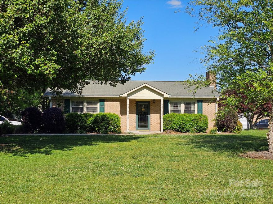 Great Brick home on over a half acre lot. Home features 2 bedrooms 1 bath. Living room have a brick fireplace with gas logs. Kitchen has a pantry, eat in island, and a dining area with a coffee bar. A good size laundry room that has a door opening to a deck.  There is a fire pit in the back yard to enjoy.  Outside building that has power and a portion at building is fenced in.