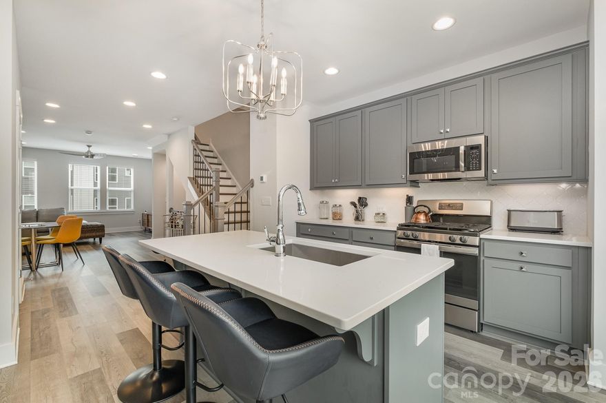 Modern, turnkey 3-story townhome built in 2023 by Empire Communities, offering an exceptional opportunity for both owner-occupants and investors in a prime location just under 2 miles west of Uptown Charlotte. This Cambria C plan features a 1-car garage with private driveway parking and a flexible, thoughtfully designed layout ideal for today’s lifestyle.

The first floor includes a versatile flex room and powder bath—perfect for a home office, gym, or secondary living space. The main living level showcases a spacious, open-concept kitchen equipped with GE stainless steel appliances, gas range, counter-depth French door refrigerator, gray painted cabinetry, quartz countertops, and a large island with a built-in double trash pullout. Sliding glass doors extend the living space outdoors to a private terrace off the kitchen, ideal for entertaining or everyday enjoyment.

Both bedrooms are located on the third floor, along with a convenient laundry closet featuring a stackable washer and dryer, which are included. The primary suite offers a private en-suite bath with gray cabinetry, quartz countertop, tiled flooring, and a fully tiled semi-frameless shower. The guest bedroom is served by a well-appointed bath with matching quartz counters, gray cabinetry, and tiled flooring. Additional powder baths provide added convenience for guests.

The property is tenant occupied and presents a strong, turn-key investment opportunity. This makes the home especially attractive for out-of-town investors or buyers looking to secure a Charlotte property now while benefiting from rental income and potential appreciation.

Ideally located near parks, walking paths, and biking trails, with restaurants, breweries, and entertainment just minutes away, this townhome offers excellent long-term rental appeal in a rapidly growing area. Do not disturb tenant. Showings by appointment only.