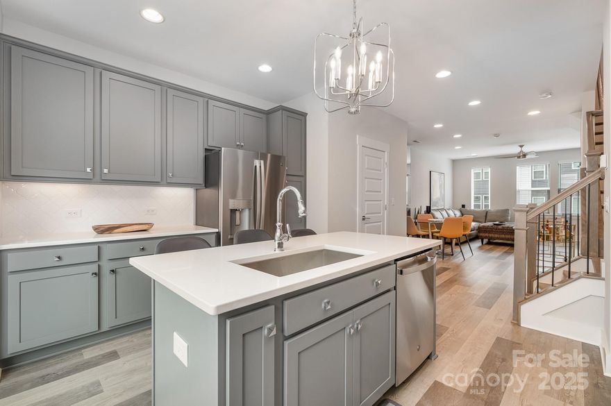 Modern, turnkey 3-story townhome built in 2023 by Empire Communities, offering an exceptional opportunity for both owner-occupants and investors in a prime location just under 2 miles west of Uptown Charlotte. This Cambria C plan features a 1-car garage with private driveway parking and a flexible, thoughtfully designed layout ideal for today’s lifestyle.

The first floor includes a versatile flex room and powder bath—perfect for a home office, gym, or secondary living space. The main living level showcases a spacious, open-concept kitchen equipped with GE stainless steel appliances, gas range, counter-depth French door refrigerator, gray painted cabinetry, quartz countertops, and a large island with a built-in double trash pullout. Sliding glass doors extend the living space outdoors to a private terrace off the kitchen, ideal for entertaining or everyday enjoyment.

Both bedrooms are located on the third floor, along with a convenient laundry closet featuring a stackable washer and dryer, which are included. The primary suite offers a private en-suite bath with gray cabinetry, quartz countertop, tiled flooring, and a fully tiled semi-frameless shower. The guest bedroom is served by a well-appointed bath with matching quartz counters, gray cabinetry, and tiled flooring. Additional powder baths provide added convenience for guests.

The property is tenant occupied and presents a strong, turn-key investment opportunity. This makes the home especially attractive for out-of-town investors or buyers looking to secure a Charlotte property now while benefiting from rental income and potential appreciation.

Ideally located near parks, walking paths, and biking trails, with restaurants, breweries, and entertainment just minutes away, this townhome offers excellent long-term rental appeal in a rapidly growing area. Do not disturb tenant. Showings by appointment only.