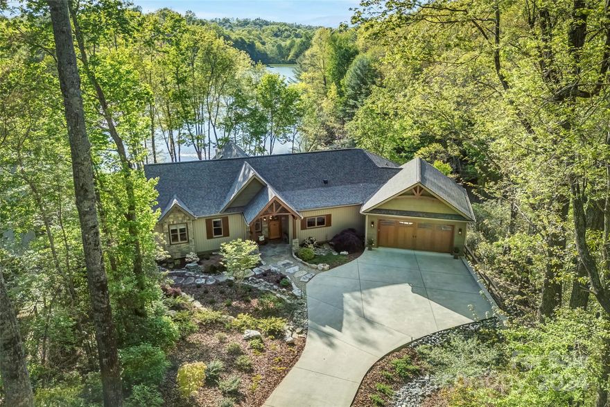 Waterfront high-end custom home centrally located in Connestee Falls. It is a premier community with an extensive range of amenities and activities from a community garden center to the state-of-the-art fitness center. The home is less than a minute from the clubhouse and resides on one of the best lakefront lots in Brevard.From the minute you walk up to the entryway through stone pillars crossing under the arched beam and through the solid oak door it's evident this home is exceptional. Once inside, the living room will grab you with it's vaulted wood ceilings, stone fireplace, and the sheer wall of windows drawing you into the views overlooking the lake.The entire great room is perfectly designed with a stunning kitchen, dining room, and direct access to 1 of 2 covered porches. The layout provides 2 guest bedrooms and a stunning primary suite on one level. The outdoor living spaces are equally impressive with established master landscaping and large private dock.*SEE VIRTUAL TOUR