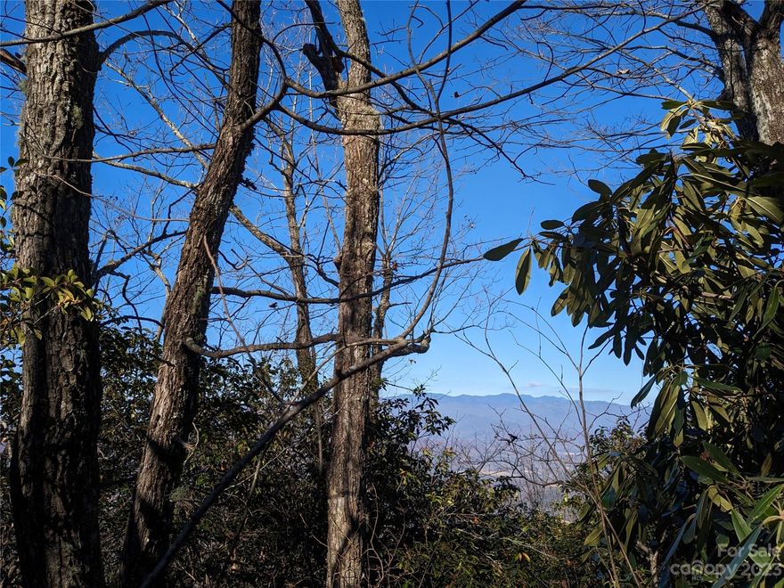 This is your chance to own one of the BEST lots within one of the BEST communities in Western NC! This lot has it all! Imagine building your home high in the mountains along a 3000ft ridge-line that offers MASSIVE views, all while having a mostly level driveway, level build site, & easy access via a well-maintained paved road?  It's not impossible! A 5-7 minute drive from your mountain hideaway will take you down to Lake George with swimming, fishing, picnicking, hiking, & a dock for kayaking or canoeing. Fiber Optic Internet just approved for installation throughout the community! Own this lot & build when ready. In the meantime, enjoy all the natural amenities of Gateway Mountain! Waterfall Park, the Trout Pond, & hiking trails! Come & see this property, in this community, & you won't want to leave! Soil testing & a survey completed in 2022. Note: Photos 9/10 not taken on property, but at a clearing on Wolf Pen Cliffs Rd facing a similar direction. This lot is in a gated community.