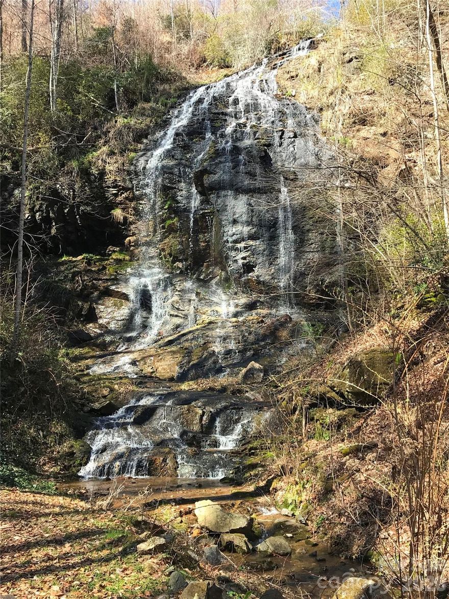 This 2.76 acre lot with fantastic views is nestled in the mountains of Polk County in a quiet, extremely private mountain property community ready for development.  Known as the area with the BEST VALUE for mountain property in the region for many reasons.  Weather: The ISOTHRMAL BELT that this specific area is located is unique in that the weather pattern is more consistent and does not have the very cold temperatures in winter or large snow falls as with other areas of the NC mountains. This ISOTHERMAL BELT allows longer enjoyable seasons with stable access to roads. Proximity to major cities.  Only 2 hours from Charlotte, 1 hour from Greenville, SC and 30 minutes from Asheville.  Easy access from interstate. This lot is located less than 15 minutes from the Saluda NC I-26 exit.  Within the boundaries of the Charleston Harbor Neighborhood, Falls Landing, there is a GORGEOUS PRIVATE WATERFALL with a community gazebo and deck for use by Falls Landing residents and their families.  The property is gated and includes a long driveway that has been cleared and developed for immediate access with 2 separate cleared flat areas to accommodate a 2 bedroom home, parking, and additional outbuilding. A small Property Owners Association with 13 total owners with minimal annual dues make up Falls Landing. The property is located along US 176 which is a North Carolina Byway with access to hiking trails, 2 additional waterfalls, and the Green River Tubing and Kayak River Tours Company.  The Great Smokey Mountains and Blue Ridge Mountains nearby are also part of this mountain chain.  It is located between the quaint mountain towns of Saluda, Brevard, and Tryon with short travel distances to Hendersonville, Asheville, Lake Lure, Chimney Rock State Park. The Tryon International Equstrain Center/Resort is close by.  There are several breweries, restaurants, outfitter stores, and wineries nearby.