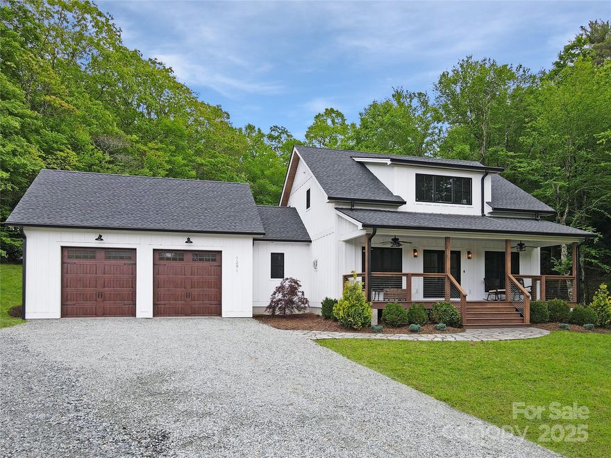 Experience the best of High Country living in this stunning new construction farmhouse just minutes from Boone, Blowing Rock, & the Blue Ridge Pkwy. Set on 5.375 acres with two creeks, open pasture, and mountain views, this home offers a rare blend of modern luxury and peaceful mountain charm. Inside, an open-concept design centers around a chef’s kitchen with GE Café appliances, gas range, and a large island perfect for gatherings. Custom-built-ins, hardwood floors, and a stone fireplace create a cozy, elegant atmosphere. Three spacious bedrooms each feature en-suite tiled baths with quartz vanities. Enjoy one-level living with the main-level primary suite, or escape to the upstairs suite with spa-like bath & claw-foot tub. Step outside to over 580 sq ft of covered outdoor space, ideal for relaxing to the sound of the spring-fed creek. With wooded privacy, open land for gardens or horses, & no HOA or deed restrictions, this is a one-of-a-kind property. Adjacent 27.69 acres available.