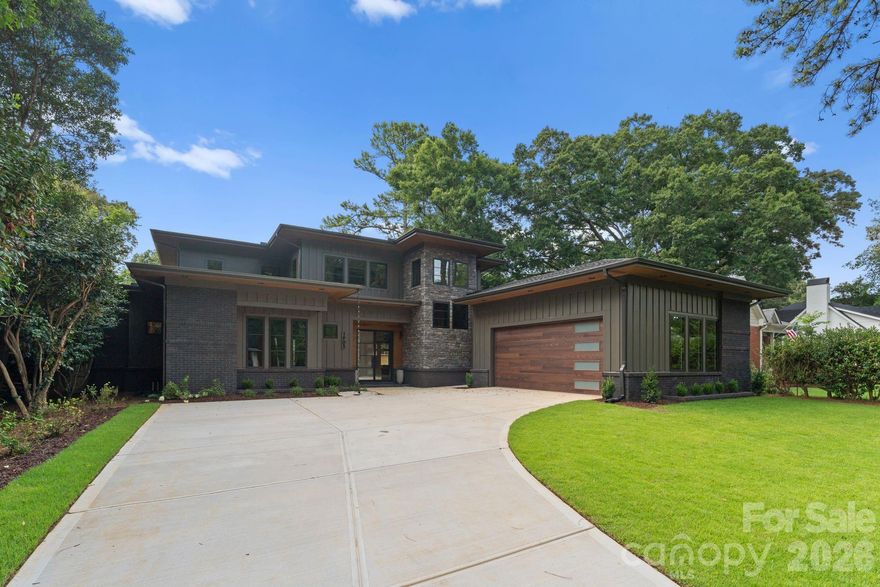 Crafted as the builder’s personal residence, this 2025 custom home by Hallmark Building Corporation is a striking modern statement in the heart of Plaza Midwood. Offering over 3,700 square feet of refined living and more than 500 square feet of covered outdoor space, the home was thoughtfully designed to connect interior and exterior living. Set on a lot with notable width for the street, it commands a strong architectural presence from the curb.

The foyer introduces an oak floating staircase and designer Hubbardton Forge lighting, setting a refined architectural tone. Large-format tile spans the main level and extends uninterrupted onto the covered terrace, reinforcing the home’s seamless transition outdoors.

The main living area opens through a three-panel panoramic sliding glass wall to the covered terrace, where a gas fireplace, integrated TV, and ceiling fans create a true outdoor living room overlooking the concrete saltwater pool with integrated hot tub and tailored hardscaping.

The kitchen balances performance and sophistication with a statement island and copper sink, leathered granite and quartz surfaces, custom cabinetry, walk-in pantry, and a full Miele appliance suite — including a range with integrated microwave/oven system. 

Privately situated on the main level, the primary suite features rich walnut flooring with matching walnut coffered ceiling, and direct terrace access. The spa bath offers a curbless zero-entry wet room with dual shower heads, complemented by the floating tigerwood double vanity. 

A dedicated office, two half baths, and the laundry room complete this level. Upstairs, three additional bedrooms and two full baths provide generous accommodations.

A one of a kind home in the heart of Plaza Midwood, thoughtfully designed and built to stand apart.