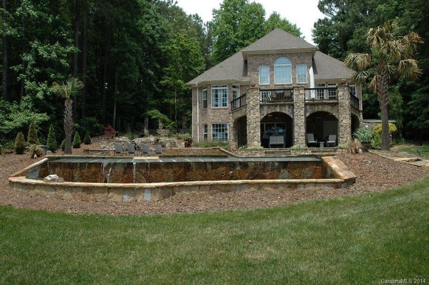Enjoy total privacy in this custom waterfront home with finished full walk-out basement on Lake Norman. 2 acres with 900 feet of shoreline and views of the State Park. Master on main. Recently remodeled kitchen includes Thermador appliances. This home is made for outdoor entertaining and lake living! Upper deck  features a custom bar with fire feature, basement has theater room, bar and heated travertine floors. Outside boasts a private pier/slip w/lift, hot tub & infinity edge saltwater pool