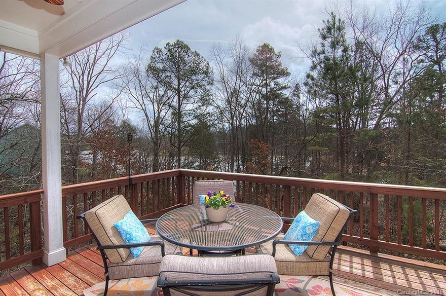 Waterfront access in Lake Shore! Perfect for canoeing, paddle boarding, swimming and fishing. Private beach shared with only 1 neighbor. Open floor plan with large living spaces and tons of upgrades. 2 porches & 2 decks to enjoy all the outdoors has to offer. Master bedroom with sitting room & luxurious bath on upper level. Finished basement with endless possibilities. Lot does not touch the water-access is by way of City of Tega Cay common area. Truly a unique find in sought after TC peninsula!